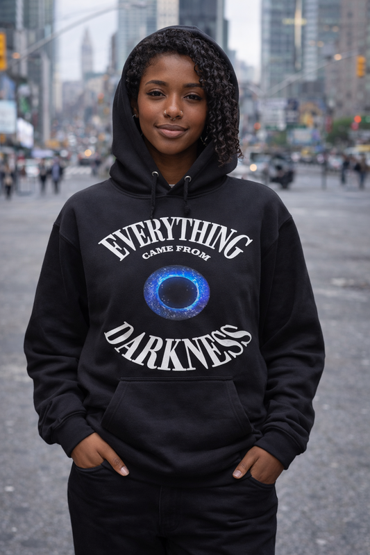 Person wearing a black hoodie with text 'Everything Came From Darkness surrounding a Black Hole.